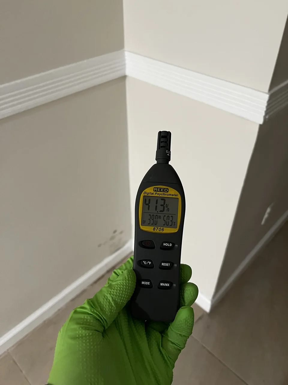 Technician measuring indoor humidity and temperature