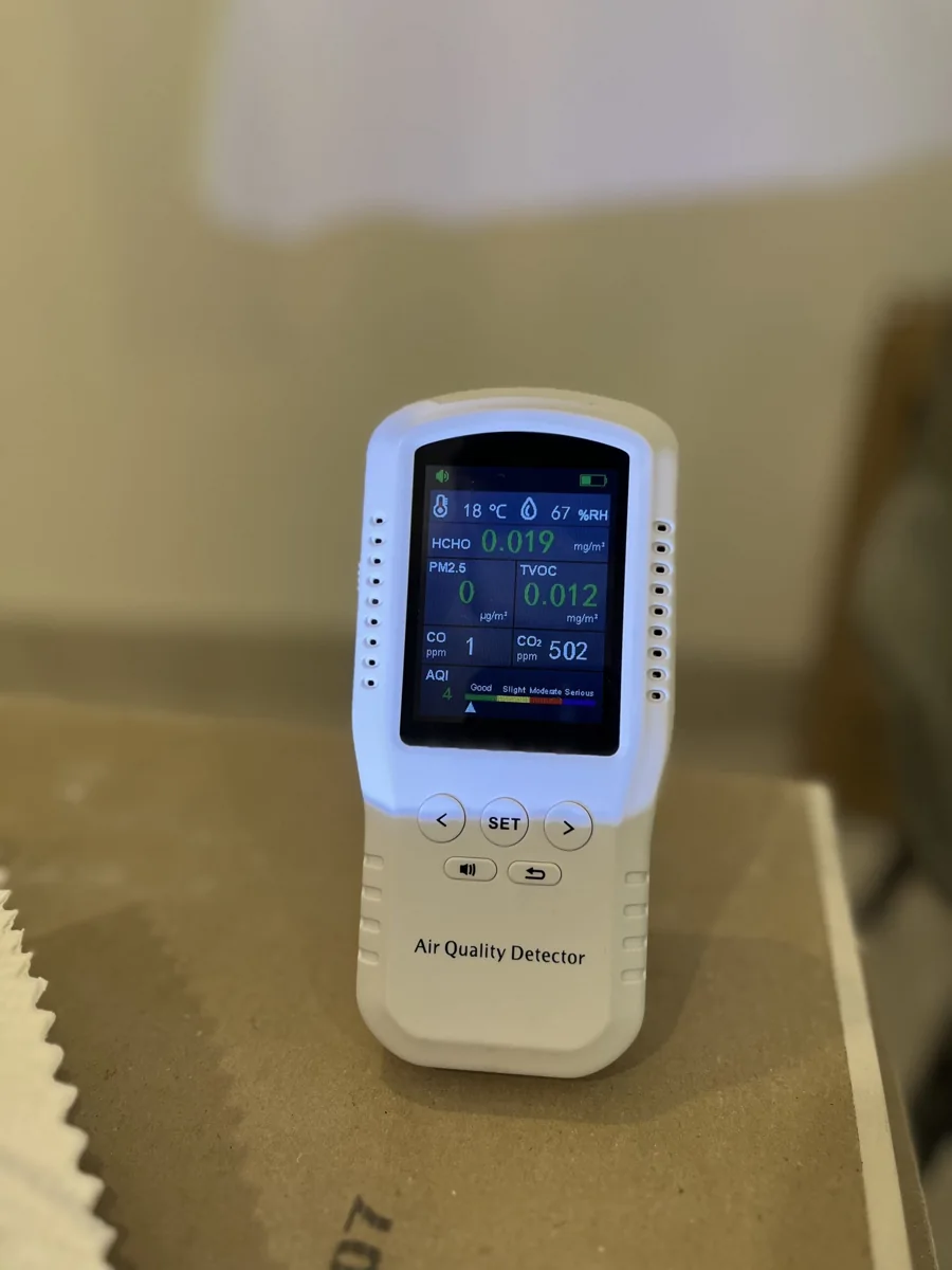 Indoor air-quality monitor displaying environmental readings