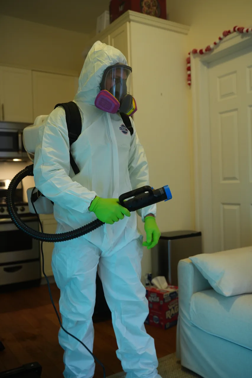 GreenRoom technician using a backpack sprayer for cleaning