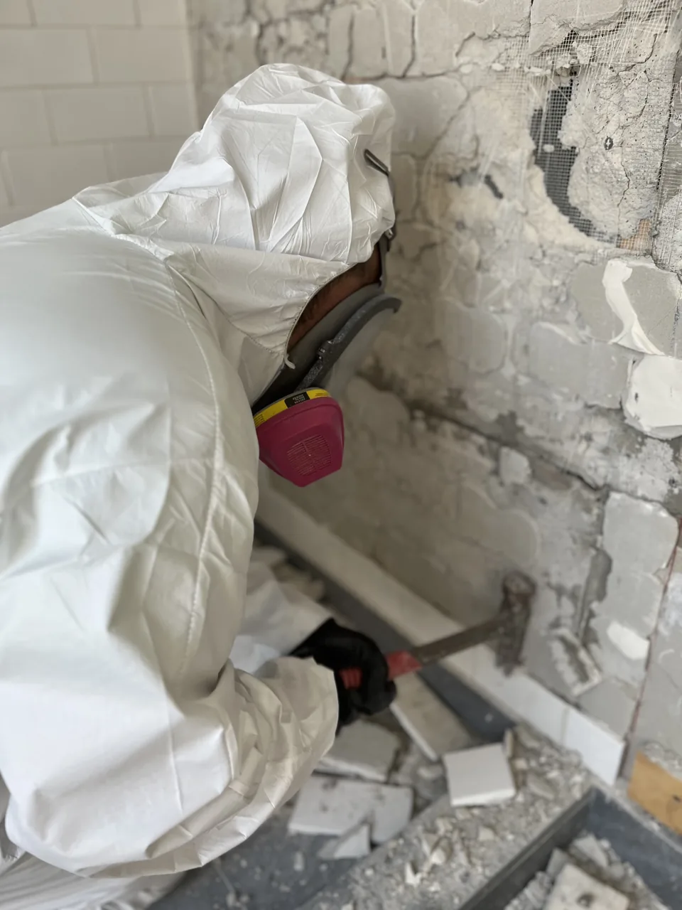 Technician Protective Equipment GreenRoom technician wearing protective equipment while working on damaged wall materials